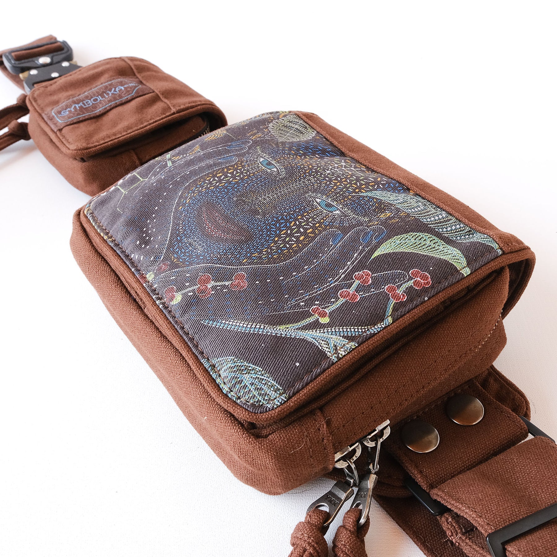 Psychedelic belt bag with UV reactive artwork worn crossbody by Symbolika