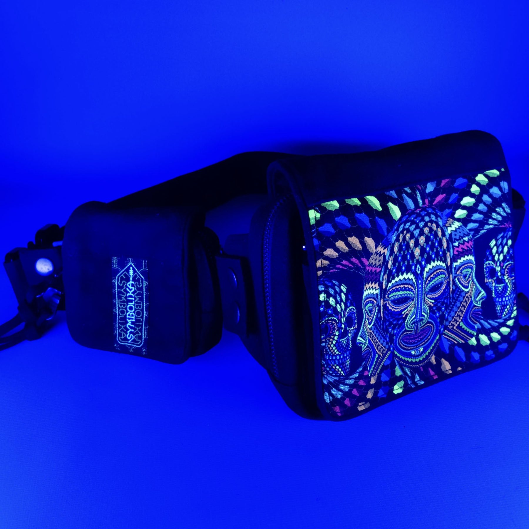 UV reactive psychedelic belt bag with geometric patterns glowing under blacklight